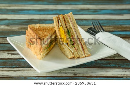 toasted sandwich with ham, cheese and vegetable on table