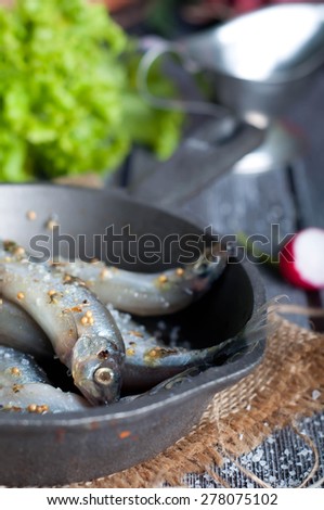 Fresh sardines. Fish with vegetables. Mediterranean fish on plate