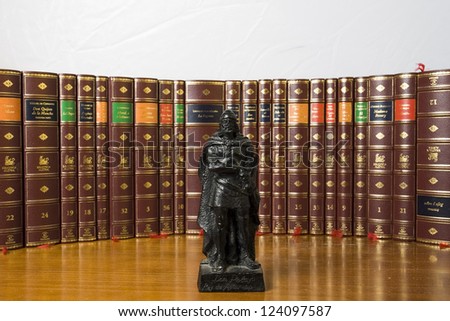 statue of Don Pelayo, King of Asturias, in front of a collection of books