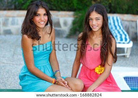 Portrait of two girls dressed to go out and sitting in the waiting pool table