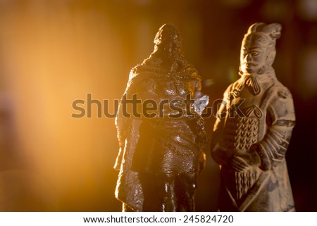figure of a warrior terracota and other ancient warrior advancing aggressive in his back