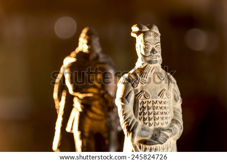 figure of a warrior terracota and other ancient warrior advancing aggressive in his back