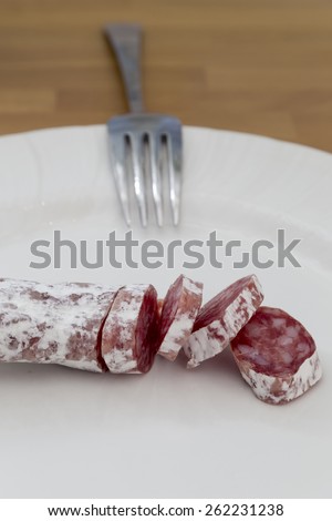 party salami on a plate with a fork