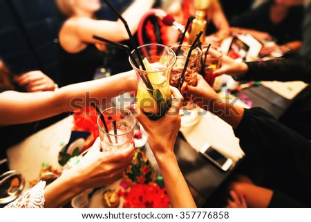 Clinking glasses with alcohol and toasting, party. Congratulations to the event. Cheerful party friends