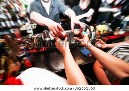 Bartender gives ready cocktails. alcoholic beverage in his hand