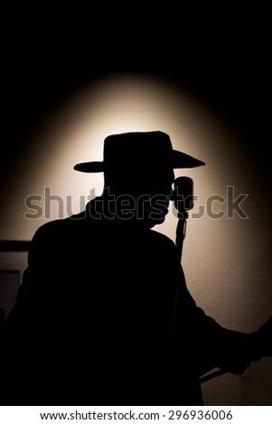 silhouette of a singer and his microphone