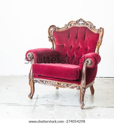 Luxury red vintage style armchair in a vintage room