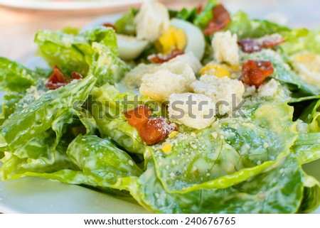 caesar salad with egg and bacon.