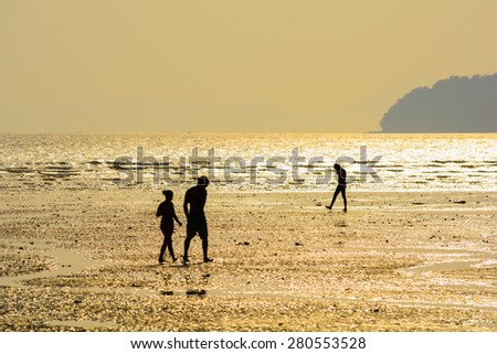 Tourists walk and play at Nang bay Krabi Thailand in sunset light.