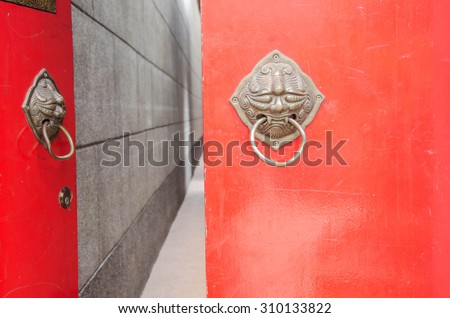 Semi-open, semi-closed \
chinese,red wood door  metal knocker lion handle, decoration of temple