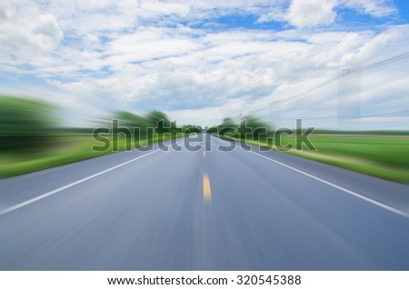 blurred motion rides along the country road  and blue sky speed logistics
