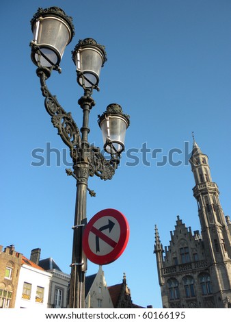 Detail of lamp , street sign and gothic church with blue sky