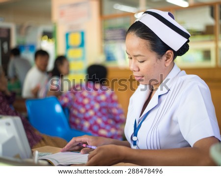 UDONTHANI THAILAND-JUNE 18 2015: Asia nurse: Woman nurse working at hospital writing medical report.