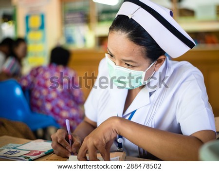 UDONTHANI THAILAND-JUNE 18 2015: Asia nurse: Woman nurse working at hospital writing medical report.