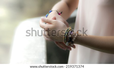 Young girl hands with jewelry.