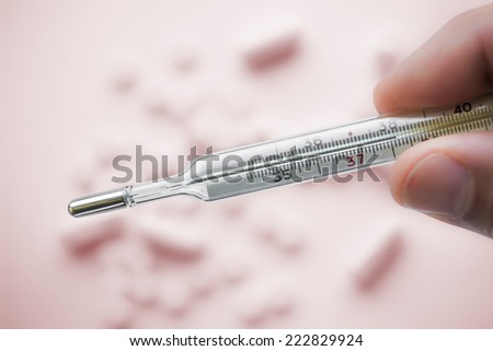Close view of mercury thermometer which showing 38C. /Mercury thermometer which showing 38C
