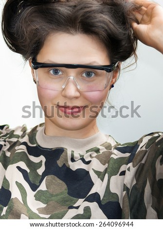Smiling girl with goggles and military shirts