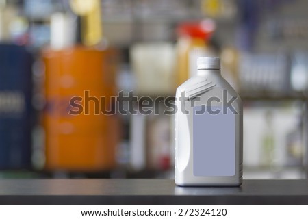 Engine oil canister with blank label in a colorful blurred background
