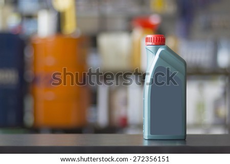 Engine oil canister with blank label in a colorful blurred background