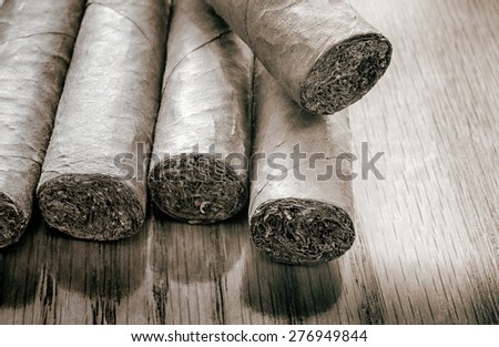 Five cigars in black white colors