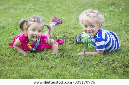 Little twins  brother and sister on a grass
