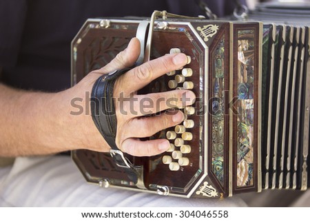 Man playing the bandoneon, traditional tango instrument, Argentina. Close view.