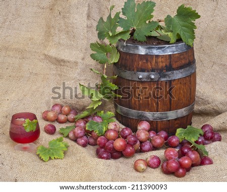 wine barrel and red ripe grape with leaves