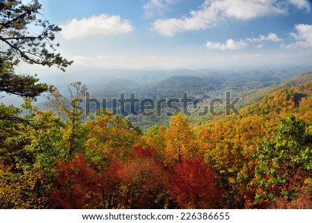 It is early in the October morning in Great Smoky Mountains National Park at the peak of autumn\'s colors. This is looking southeast into the Smoky mountains from the Foothills Parkway West.