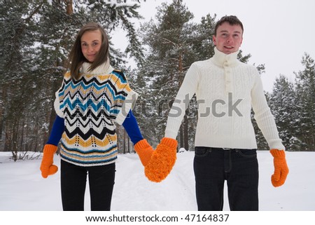 Young people walk in wood in winter