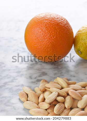 Minimal Still Life with Orange, Lemon and Almonds Close Up