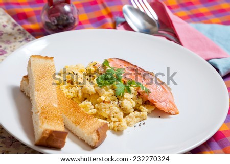 Cheesy Scrambled Eggs with Salmon served with buttered toast