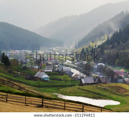 Rural landscape with village houses and mountains. Spring of Carpatian. Panorama.