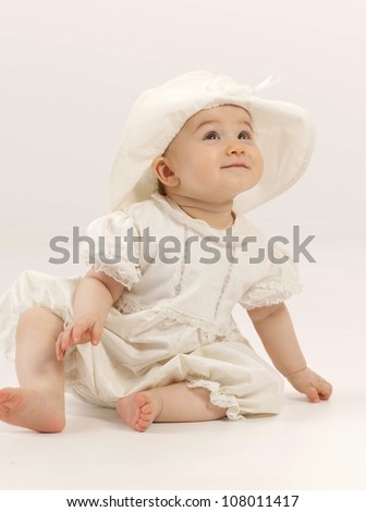 little child baby girl sitting on the chair indoors smiling hat dress little child baby girl sitting on the chair indoors smiling hat dress