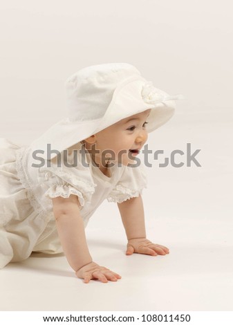little child baby girl sitting on the floor indoors in baby room smiling hat dress fashion little child baby girl sitting on the floor indoors in baby room smiling hat dress fashion