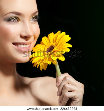 closeup portrait of attractive  caucasian smiling woman  studio shot lips toothy smile face closeup skin makeup head  tooth eyes flower yellow