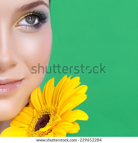 closeup portrait of attractive  caucasian smiling woman  studio shot lips face closeup head makeup skin flower yellow