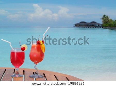 two red cocktails on the table on the beach , summer, sea, ocean, vacation