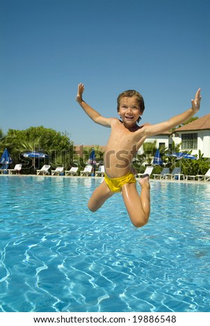 happy boy jumping into the pool , smiling, summer, resort, vacation, swimming