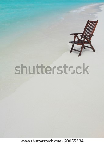 wooden chair on the beach  on the sand near the water, summer, vacation, recreation, ocean,sea, travel