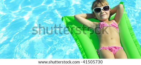 girl near the swimming pool in  sun glasses
