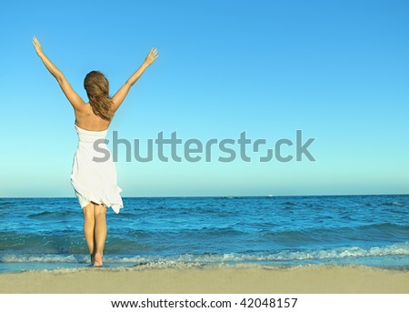 attractive woman in white dress on the beach back