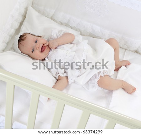 little child baby lying in the bed smiling