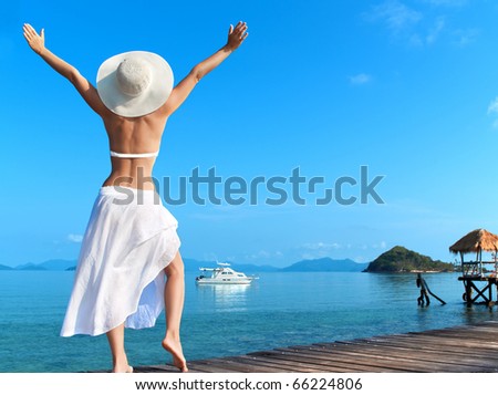 Woman  on the beach standing back