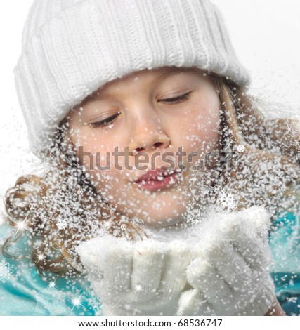 cute little girl in warm hat and gloves blowing snow on white background