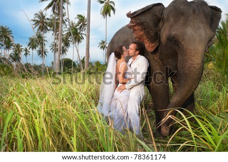 beautiful couple with elephant inwedding dress