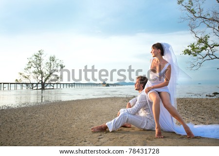 stock photo beautiful couple on the beach in wedding dress
