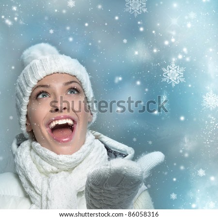beautiful woman in warm clothing with snow