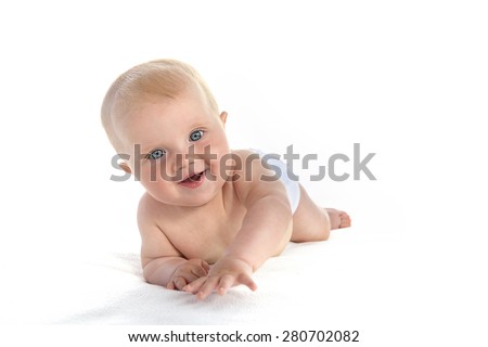 baby girl child lying down on white blanket smiling happy portrait face studio shot isolated on white caucasian