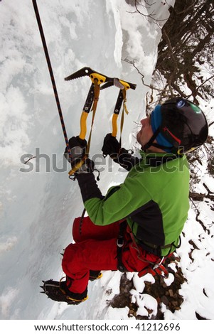 Man climbing a frozen waterfall