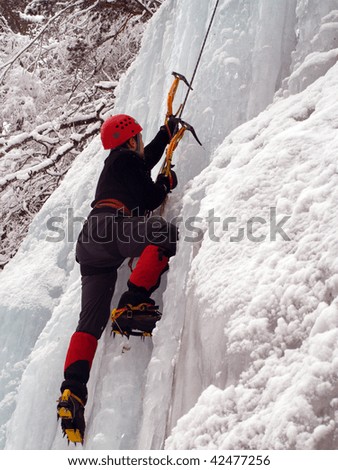 Man climbing a frozen waterfall